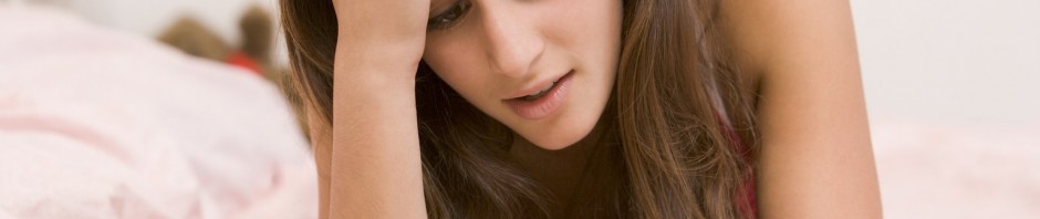 Teenage Girl Lying On Her Bed With A Pregnancy Test